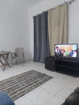 a living room with a flat screen tv on a table at one bed Apartment In Al Makramia in Hurghada