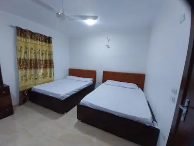 a bedroom with two beds and a window at Emad villa in Hurghada