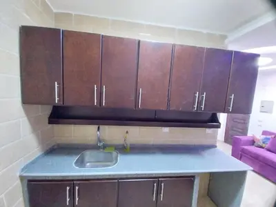 a kitchen with a sink and some wooden cabinets at Emad villa in Hurghada