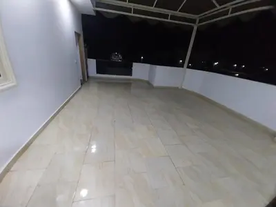 a large empty room with a white wall and a tile floor at Emad villa in Hurghada