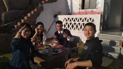 a group of people sitting around a table with a cake at Onaty Narty Guest house Nile view in Aswan