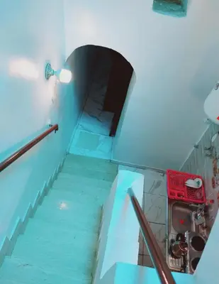 a staircase in a room with blue floors and a glass floor at Nubian Amego Gaust House in Aswan