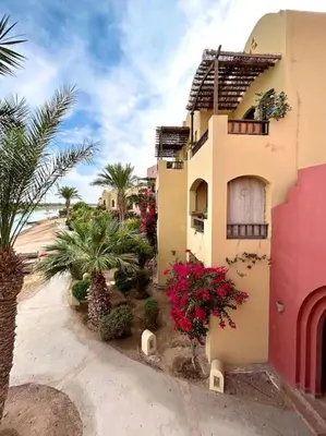 a building with flowers and plants in front of it at SunShine Y1-1-19 in Hurghada