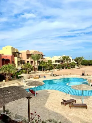 a resort with a swimming pool with umbrellas at SunShine Y1-1-19 in Hurghada