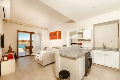 a kitchen and living room with a view of the ocean at Sabina Lagoon view 2BR Apartment in Hurghada