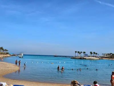 a group of people in the water at a beach at Noura Luxury Hotel Villa with free Pool and Beach access in Hurghada in Hurghada