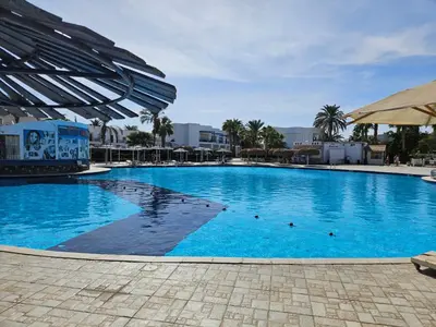 a large blue swimming pool in a resort at Noura Luxury Hotel Villa with free Pool and Beach access in Hurghada in Hurghada