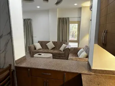 a living room with a couch and a large mirror at Noura Luxury Hotel Villa with free Pool and Beach access in Hurghada in Hurghada