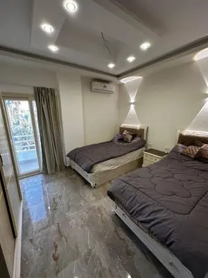a bedroom with two beds and a window at Noura Luxury Hotel Villa with free Pool and Beach access in Hurghada in Hurghada