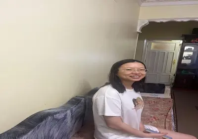 a woman sitting on a bed in a room at Alara Hostel 
