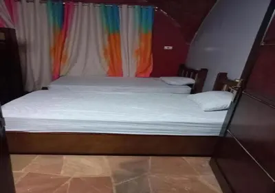 a bed in a room with a rainbow curtain at Alara Hostel 