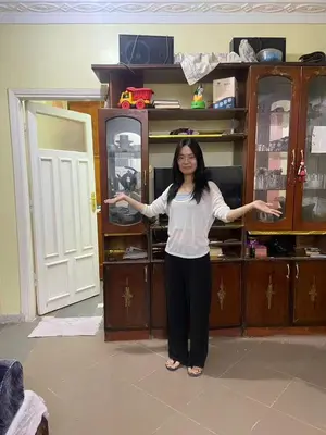 a woman standing in front of a cabinet at Alara Hostel 