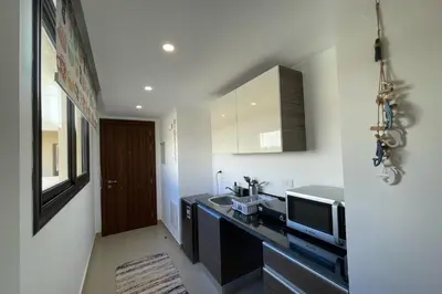 a kitchen with a sink and a tv on a counter at The Senseful Studio G Cribs in Hurghada
