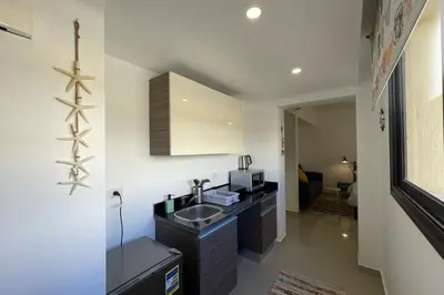 a small kitchen with a sink and a microwave at The Senseful Studio G Cribs in Hurghada