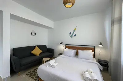 a bedroom with a bed and a couch at The Senseful Studio G Cribs in Hurghada