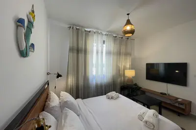 a bedroom with a bed and a flat screen tv at The Senseful Studio G Cribs in Hurghada