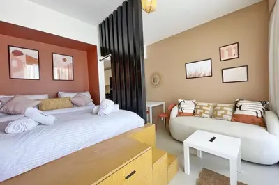 a bedroom with two beds and a couch at The Snuggly Studio G Cribs El Gouna in Hurghada