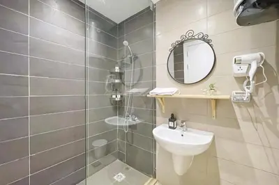 a bathroom with a shower and a sink and a mirror at The Snuggly Studio G Cribs El Gouna in Hurghada