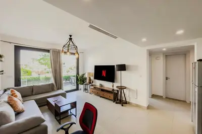 a living room with a couch and a tv at Cordial & Cozy 1 BDR G Cribs in Hurghada