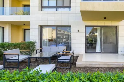 a patio with a table and chairs in front of a building at Cordial & Cozy 1 BDR G Cribs in Hurghada
