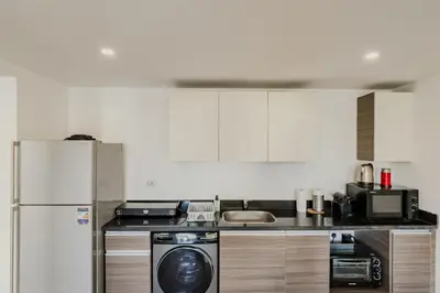 a kitchen with a refrigerator and a dishwasher at Cordial & Cozy 1 BDR G Cribs in Hurghada