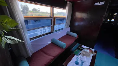 a room with a bench in front of a window at Freedom Houseboat in Aswan
