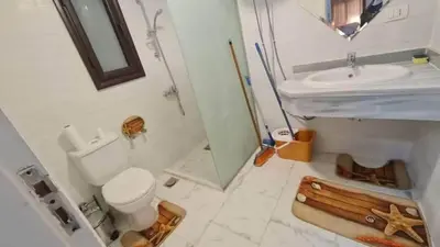 a bathroom with a toilet and a sink and a mirror at Turtles Beach resort hourghada Studio view sea view pool private beach Pools balcony security Cafe and restaurant on pool jacuzzi air-condition sunny a large balcony in Hurghada