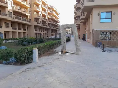 a sculpture on a sidewalk in front of a building at Turtles Beach resort hourghada Studio view sea view pool private beach Pools balcony security Cafe and restaurant on pool jacuzzi air-condition sunny a large balcony in Hurghada