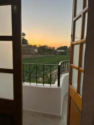 a view of a balcony with a view of a field at Lemon Tree apartments luxor in Al Aqālitah