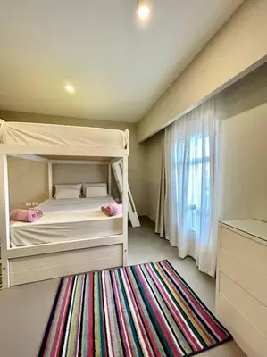 a small bedroom with a bunk bed and a rug at SunShine AbuTig Marina in Hurghada