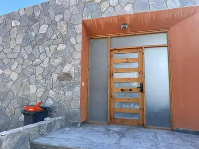 a door to a building with a stone wall at Baywest Villa, Somabay in Safaga