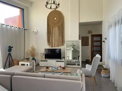 a living room with a couch and a tv at Baywest Villa, Somabay in Safaga