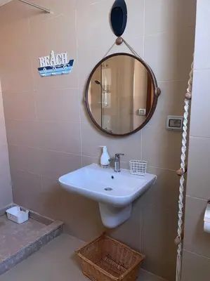 a bathroom with a sink and a mirror on the wall at Baywest Villa, Somabay in Safaga
