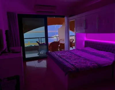 a purple bedroom with a bed with a purple light at The View Residence Studio in Hurghada
