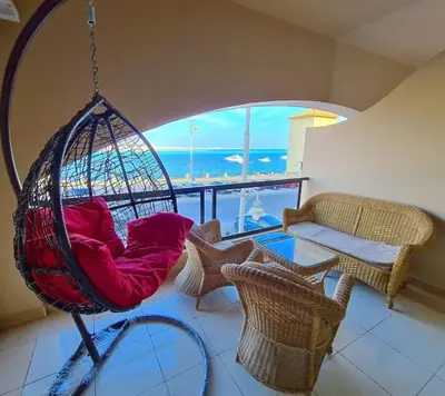 a swing in a living room with a view of the ocean at The View Residence Studio in Hurghada