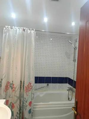 a bathroom with a tub and a shower curtain at The View Residence Studio in Hurghada