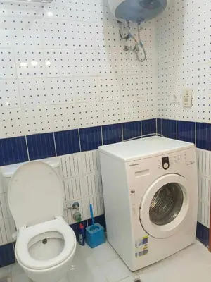 a bathroom with a washing machine and a toilet at The View Residence Studio in Hurghada