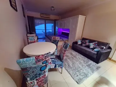 a living room with a table and chairs and a couch at The View Residence Studio in Hurghada