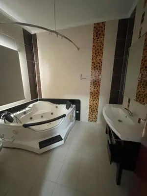 a large bathroom with a tub and a sink at Hurghada-Magawish Villa 6 in Hurghada