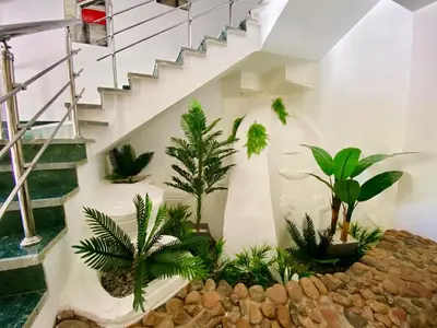 a room with a staircase with plants at Hurghada-Magawish Villa 6 in Hurghada