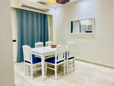 a dining room with a white table and chairs at Hurghada-Magawish Villa 6 in Hurghada
