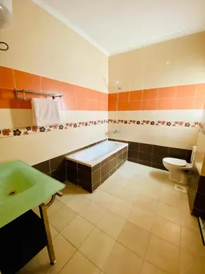 a bathroom with a tub and a toilet and a sink at Hurghada-Magawish Villa 6 in Hurghada