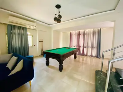 a living room with a pool table in it at فيلا 1☆ in Hurghada