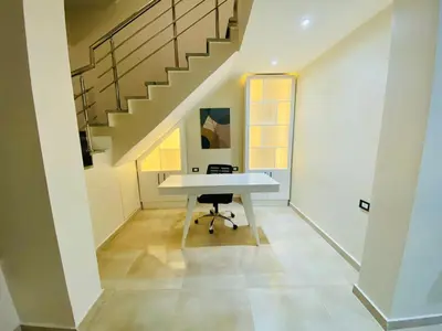 a desk in a hallway with a staircase at فيلا 1☆ in Hurghada