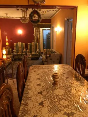a dining room with a table and chairs at Dr milad shokralla multiple central flats in Luxor
