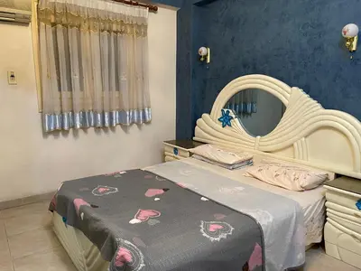 a bedroom with a bed and a large mirror at Dr milad shokralla multiple central flats in Luxor