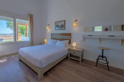 a bedroom with a large bed and a window at unique flat_ garden and lagoon in Hurghada