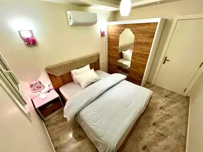 a small bedroom with a white bed and a mirror at Selena Bay Resort & beach in Hurghada