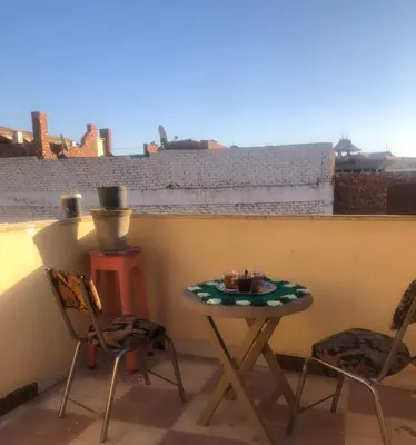 a small table and two chairs on a balcony at NUB Guest House in Aswan