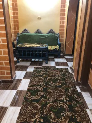 a hallway with a bench with a rug on the floor at NUB Guest House in Aswan